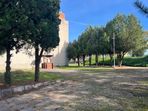 an empty parking lot with trees and a building at Chrám Ticha in ľubá
