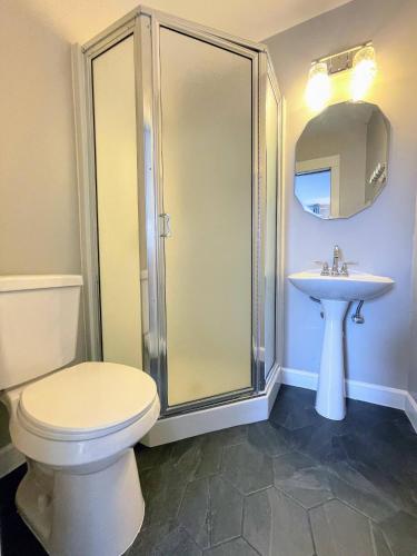 a bathroom with a shower and a toilet and a sink at Lake Chelan Manor Room #2 in Chelan