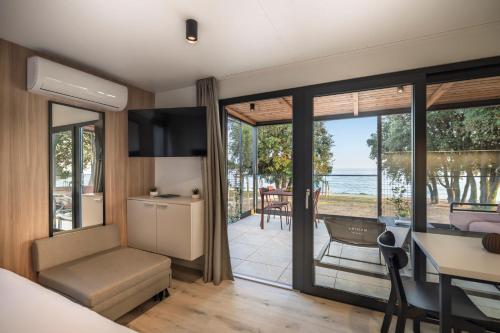 a bedroom with a view of the ocean at Maistra Camping Koversada Covered Mobile homes in Vrsar
