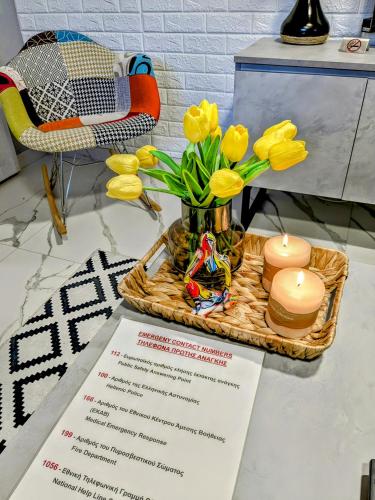 a table with a menu and yellow flowers and candles at Vergina Luxury Apartment in Vergina