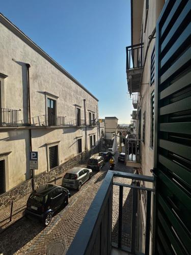 a balcony with cars parked on a street next to buildings at Lindas Room in Pozzuoli