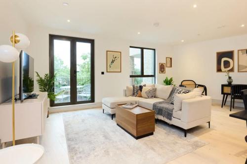 a living room with a couch and a table at The South Wimbledon Place - Adorable 2BDR Flat with Balcony in London