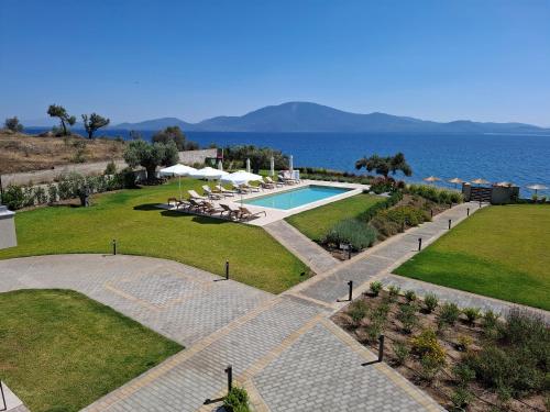 a resort with a swimming pool and the ocean at SeaSide Village in Politiká