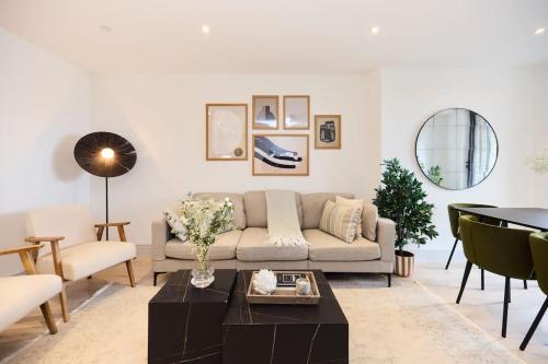 a living room with a couch and a table at The South Wimbledon Escape - Lovely 3BDR with Balcony in London