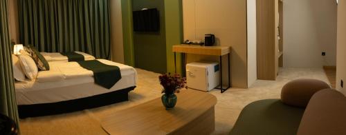 a hotel room with a bed and a coffee table at MSInternational Hotel in Ulaanbaatar