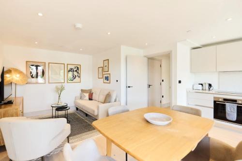 a living room with a table and a couch at The South Wimbledon Hideout - Fancy 1BDR Flat with Balcony in London