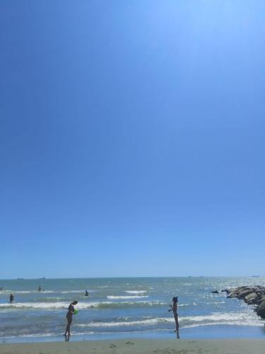 people playing in the water at the beach at Villa Ornella in Luni