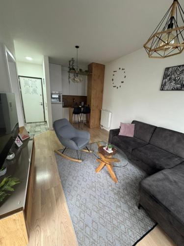 a living room with a couch and a table at APARTMANI Bulevar in Sarajevo