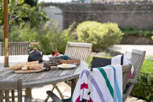 a picnic table with bread and cheese on it at The Garden House in Bath