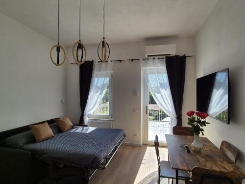 a living room with a bed and a table at Superior Suite, Villa Joy Verona, Luxury Romantic Suite with Jacuzzi, near City Center in Verona