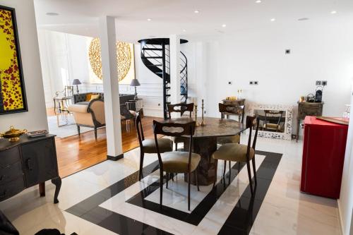 a dining room and living room with a table and chairs at Luxury Duplex 2BR Panoramic Sea View Monaco in Beausoleil