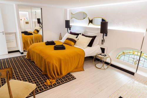 a bedroom with two beds and a mirror at Luxury Duplex 2BR Panoramic Sea View Monaco in Beausoleil