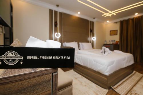 a hotel room with a bed and a sign that says imperialipsips interests way at Rotana Pyramids View in Cairo