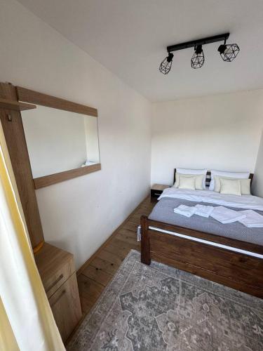 a small bedroom with a bed and a mirror at Готель White House in Yablunytsya