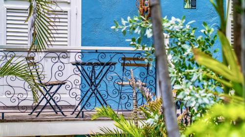 a blue building with two chairs on a balcony at Pietermaai Boutique Hotel in Willemstad