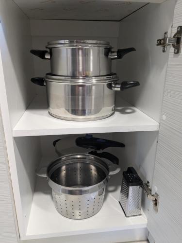 a kitchen with two pots and pans on a shelf at Vergina Luxury Apartment in Vergina