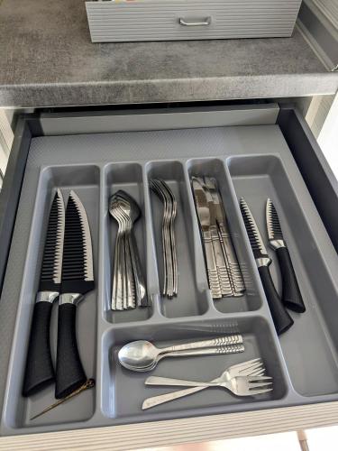 a tray of utensils in a drawer in a kitchen at Vergina Luxury Apartment in Vergina