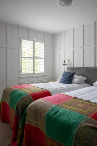 two beds sitting next to each other in a bedroom at Tannery Townhouse in Dungarvan