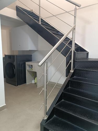 a staircase with a metal railing in a building at Moderno Apartamento en el Norte de Cali in Cali