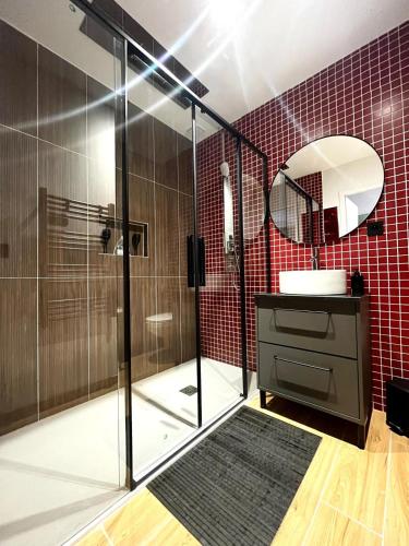 a bathroom with a shower with a sink and a mirror at Le Ryokan douche sensorielle in Le Muy