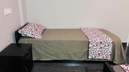 a bed with two pillows on it in a room at Samuels Comfort Homes in Bengaluru