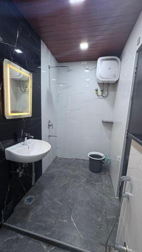 a small bathroom with a sink and a toilet at VV Guest Inn in Nellore