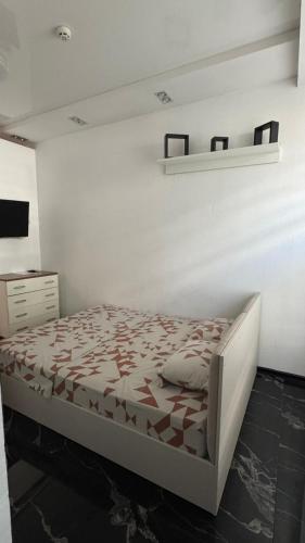 a bedroom with a bed and a shelf on the wall at Royal Suite in Odesa
