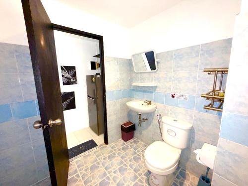 a bathroom with a toilet and a sink at Patong Canal Villa R201 in Patong Beach
