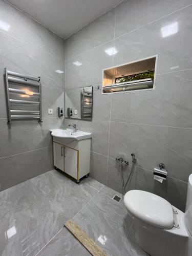 a bathroom with a toilet and a sink at Magnificent view with 6 beds in Gabala