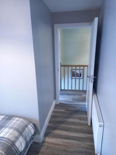 an open door leading to a hallway with a bed at Cosy three bedroom house in Ballingarry Limerick near Adare in Balnacart