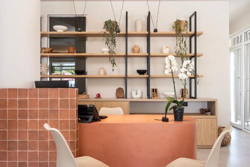 a room with a table and chairs and shelves at Time to Smile Saline in Tigaki
