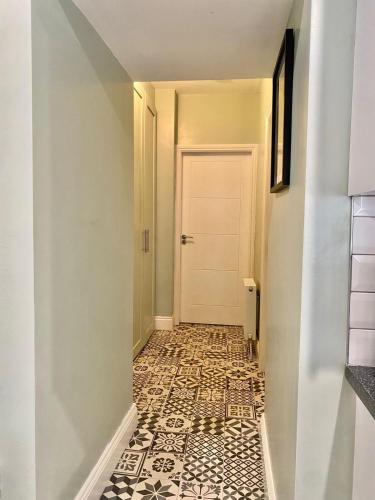 a hallway with a door and a tile floor at Cosy three bedroom house in Ballingarry Limerick near Adare in Balnacart