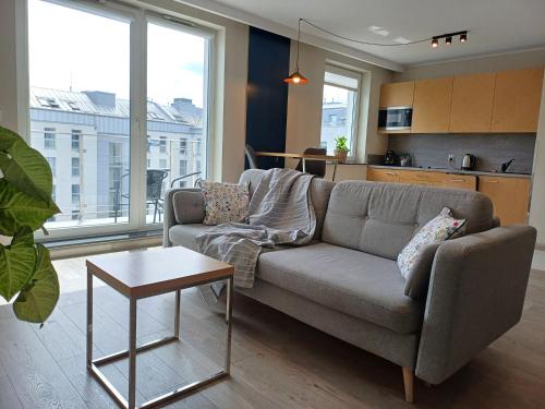 a living room with a couch and a table at Hotel Marina Club Old Town View in Gdańsk