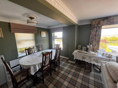 a dining room with a table and chairs at Beau Vista in Strabane