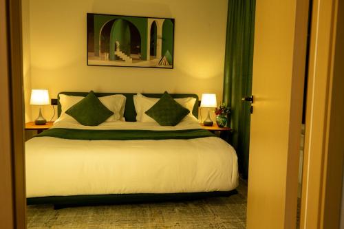 a bedroom with a bed with green curtains and two lamps at MSInternational Hotel in Ulaanbaatar