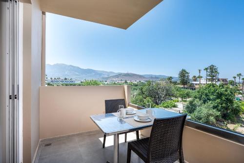 a dining room with a table and chairs and a large window at Time to Smile Saline in Tigaki