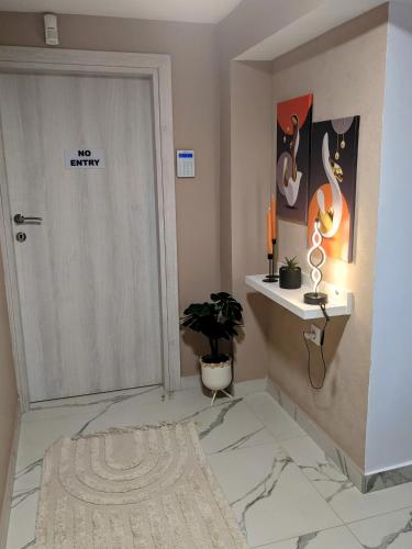 a room with a door with a plant and a rug at Vergina Luxury Apartment in Vergina