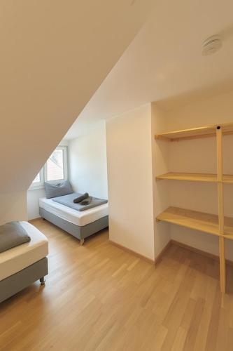 a bedroom with a bed and shelves in a room at Modern Flat Karlsruhe - Waschmaschine, Fußbodenheizung, Regendusche in Karlsruhe