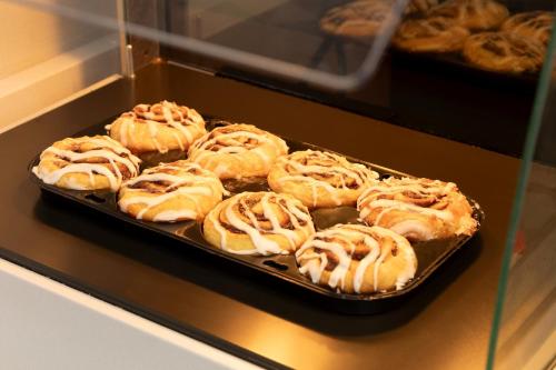 a tray of pastries in a display case in a bakery at Holiday Inn Express & Suites Chicago West - St Charles by IHG in Saint Charles