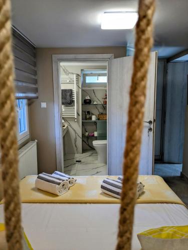a bathroom with two towels on a table in a room at Vergina Luxury Apartment in Vergina