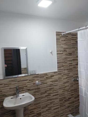 a bathroom with a sink and a mirror at Casa Patagónica Los Charitos in El Chalten