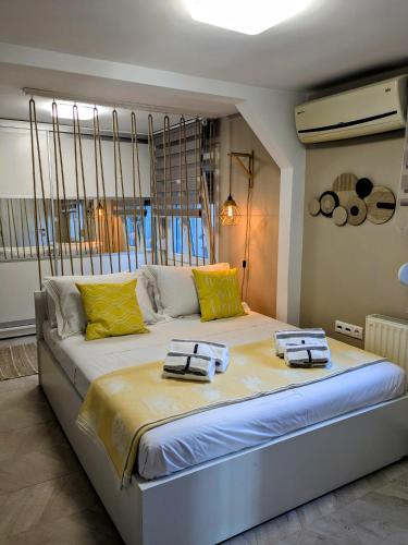 a large bed with two towels on it in a room at Vergina Luxury Apartment in Vergina