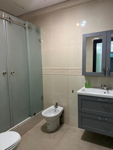 a bathroom with a toilet and a sink and a shower at Beach palace 1 between sea pool and city center in Mohammedia
