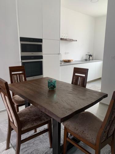 a kitchen with a wooden table and chairs at Near Everything Apartment in Győr