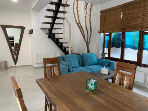 a living room with a table and a blue couch at Near Everything Apartment in Győr