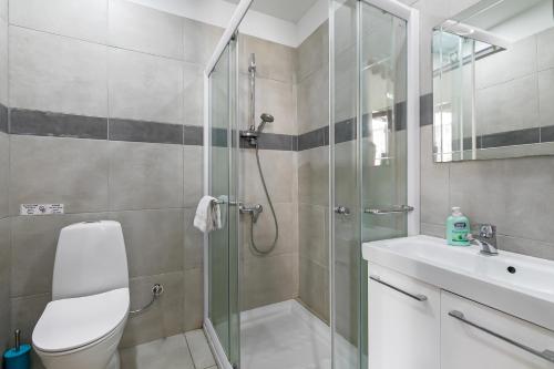 a bathroom with a shower and a toilet and a sink at Bluearches in Pano Lefkara