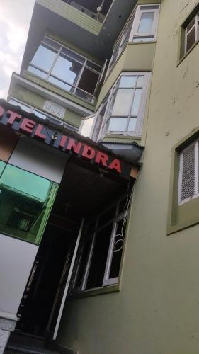 a building with a sign on the side of it at Hotel Indra in Srinagar