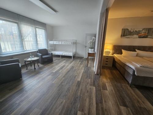 a bedroom with a bed and a desk and a chair at Hotel Adler - Weil am Rhein in Weil am Rhein