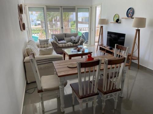 a living room with a table and chairs and a couch at Almaza bay Beach Town Chalet in Marsa Matruh