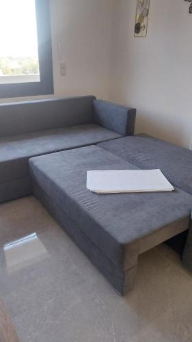 a bed sitting in a room with a table at F & A Family Home in Zarós